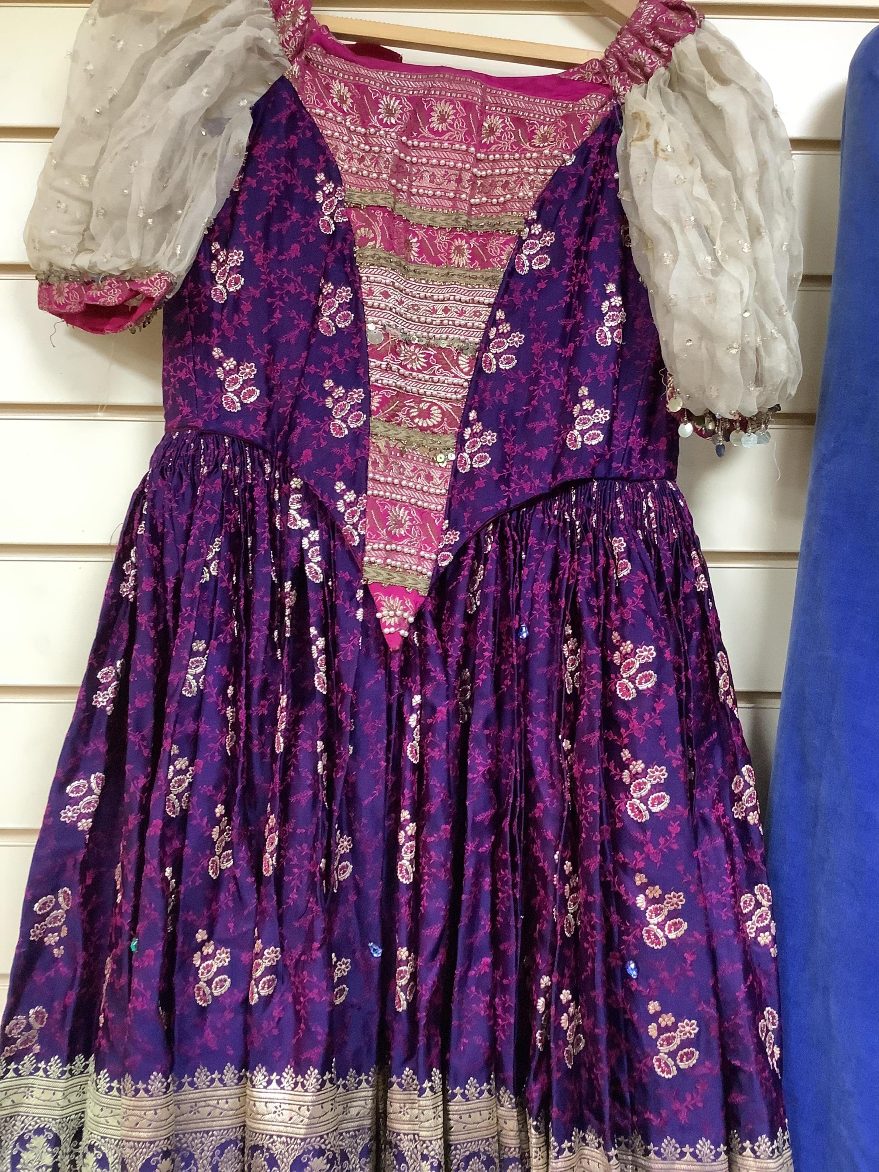 A child’s theatrical brocade dress and a lady’s blue velvet, cream and silk-lined cape, labelled Jenners, Edinburgh- 116cm long.